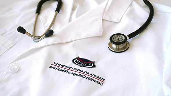 FAU Schmidt College of Medicine white coat with stethoscope